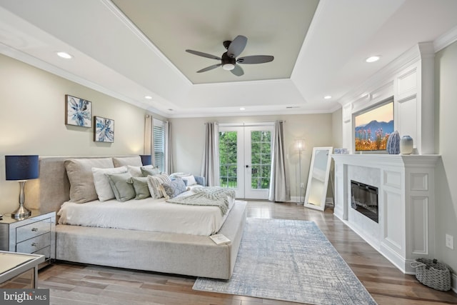 3357 Huntingdon Pike, Huntingdon Valley, PA 19006 - bedroom featuring a tray ceiling, access to exterior, crown molding, wood finished floors, and a glass covered fireplace