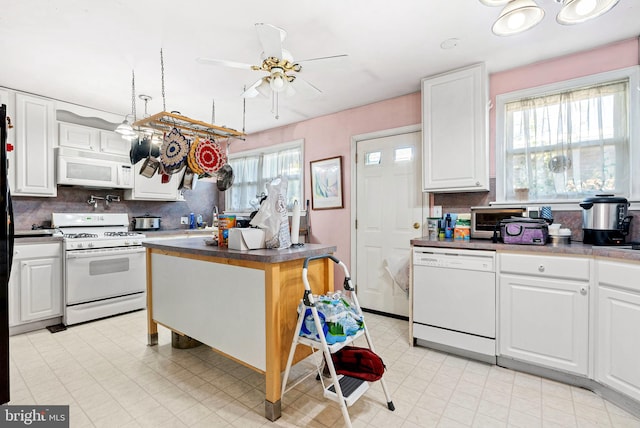 kitchen with tasteful backsplash, white appliances, ceiling fan, and white cabinets