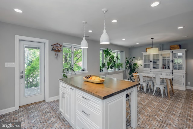 kitchen featuring recessed lighting, a wealth of natural light, and wooden counters
