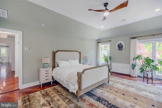 bedroom featuring radiator heating unit, multiple windows, and visible vents