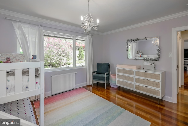 bedroom featuring an inviting chandelier, ornamental molding, wood finished floors, baseboards, and radiator heating unit