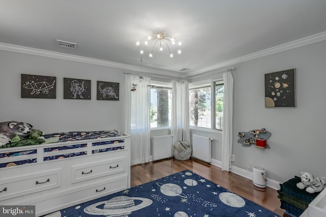 bedroom with visible vents, ornamental molding, and radiator heating unit