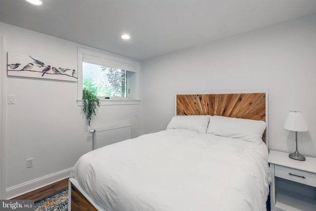 bedroom featuring recessed lighting, baseboards, dark wood-style floors, and radiator heating unit