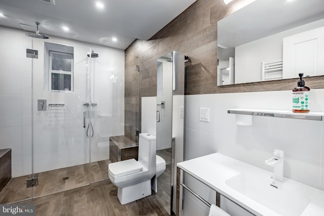 full bath featuring toilet, tile walls, a shower stall, and recessed lighting
