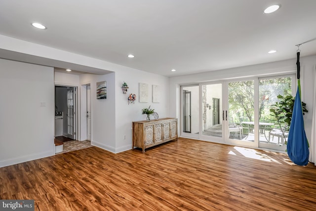 interior space with recessed lighting, baseboards, and wood finished floors