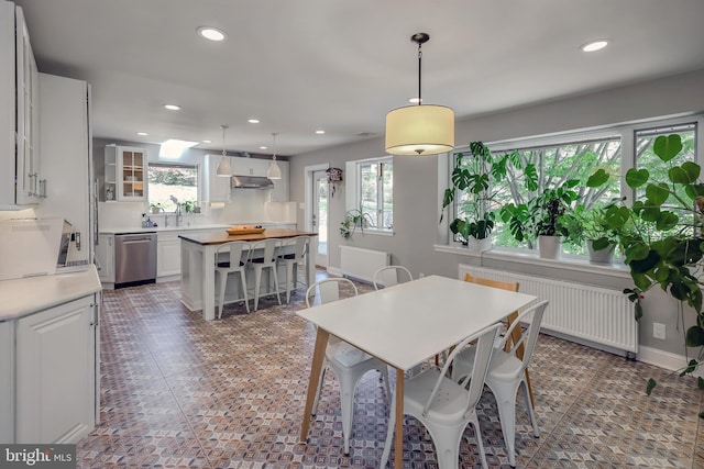 dining space with radiator heating unit, tile patterned floors, baseboards, and recessed lighting
