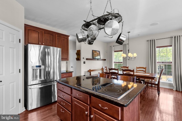 kitchen featuring an inviting chandelier, plenty of natural light, black electric stovetop, and stainless steel fridge with ice dispenser