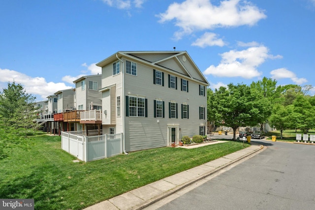view of side of property with a lawn