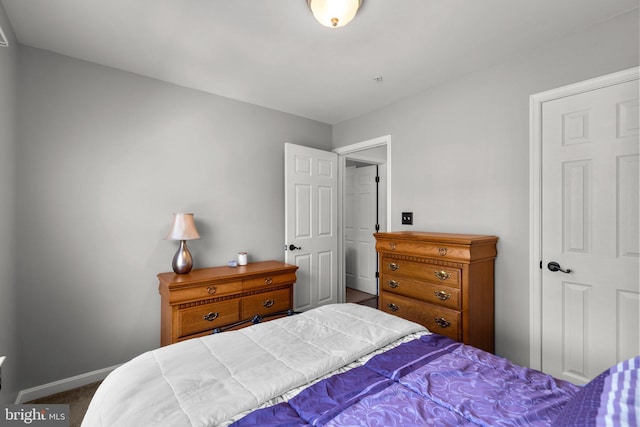 bedroom featuring baseboards and carpet