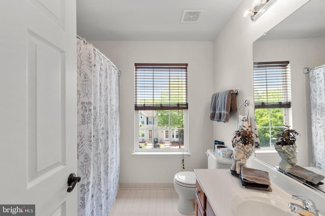 bathroom with toilet, visible vents, a healthy amount of sunlight, and vanity