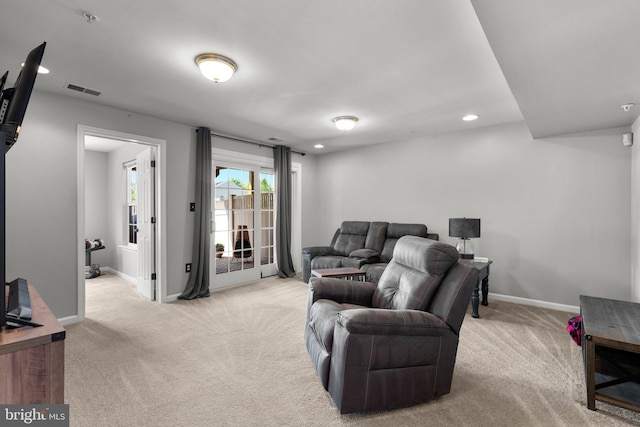 living area with recessed lighting, baseboards, and light carpet