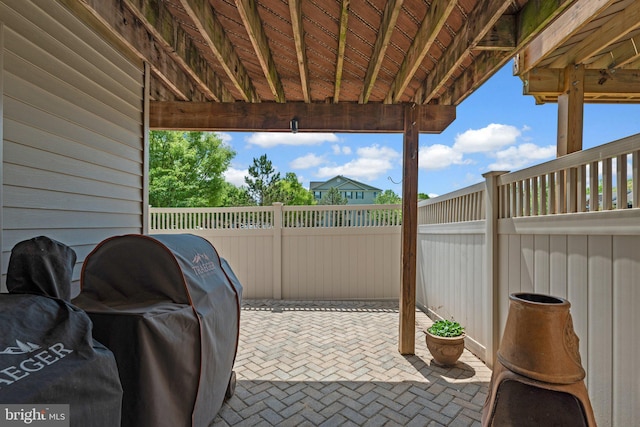 view of patio featuring area for grilling and fence