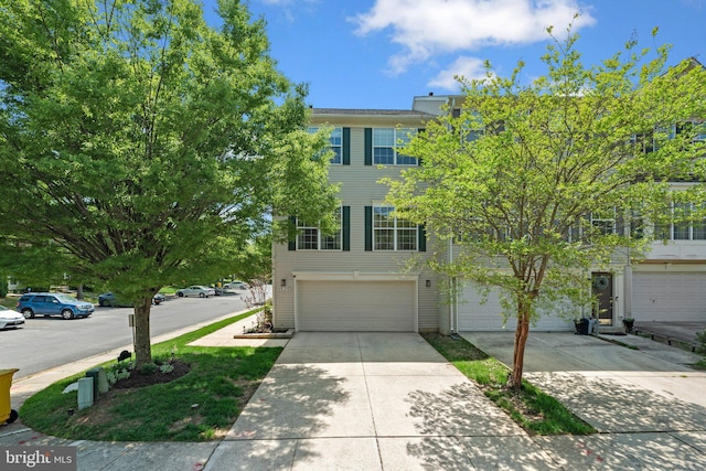 multi unit property with a garage and concrete driveway