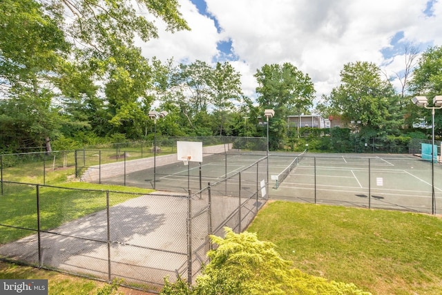 view of sport court featuring community basketball court, fence, a yard, and a tennis court