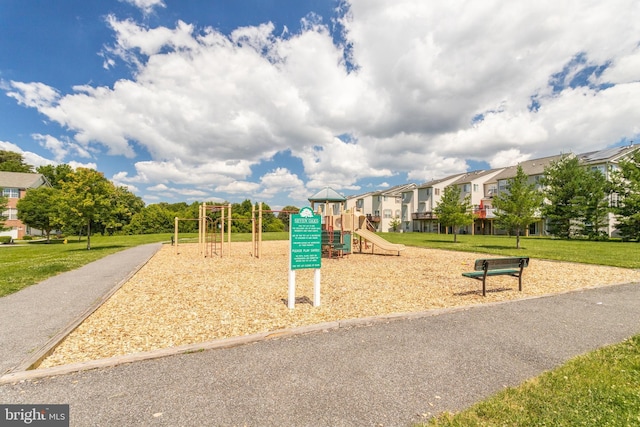 community jungle gym with a lawn and a residential view