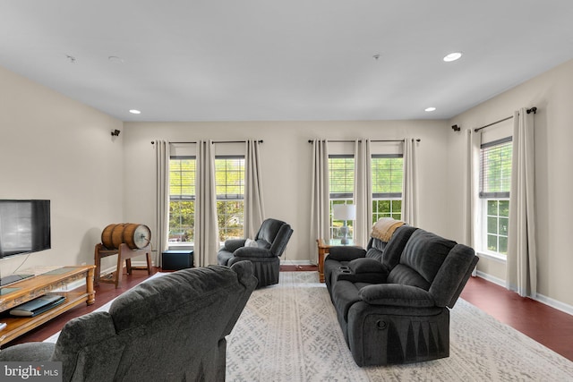 living room featuring baseboards, plenty of natural light, recessed lighting, and wood finished floors