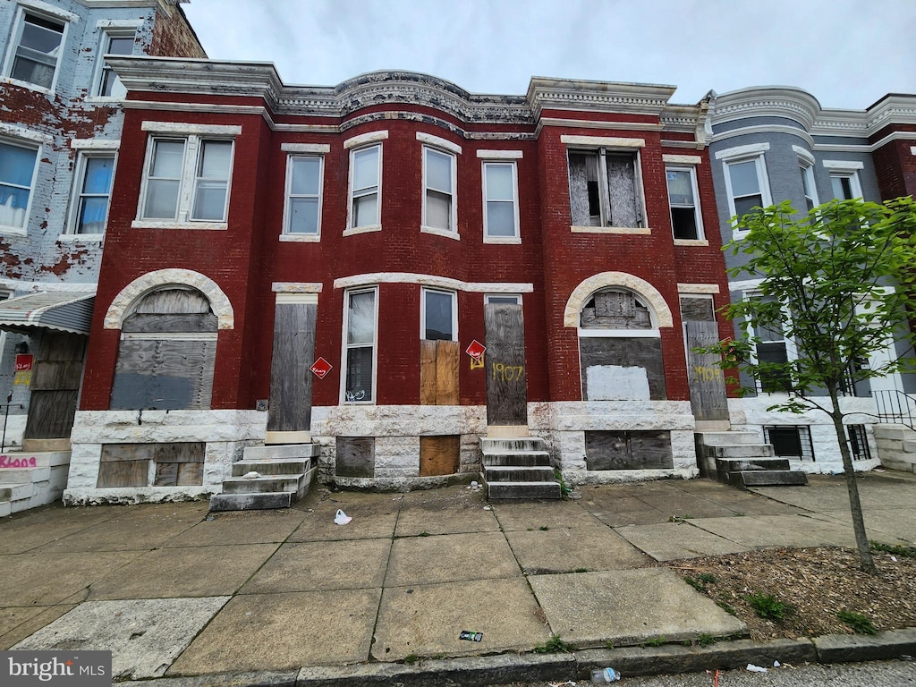 view of property with entry steps and brick siding