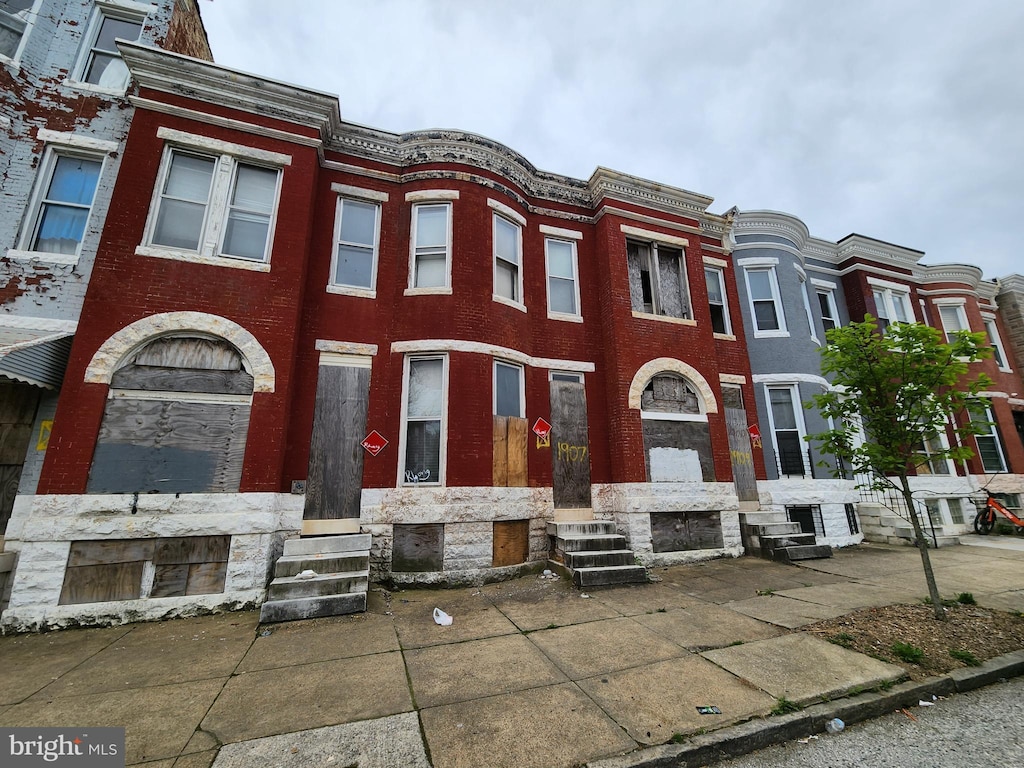 view of property with brick siding and entry steps