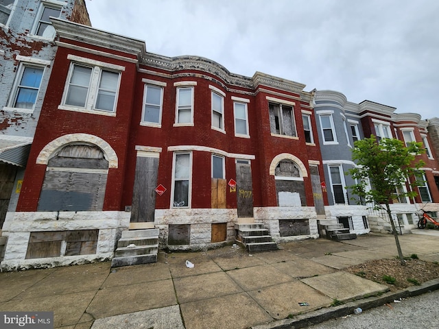 view of property with brick siding and entry steps