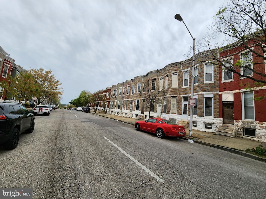 view of street with sidewalks, street lighting, and curbs