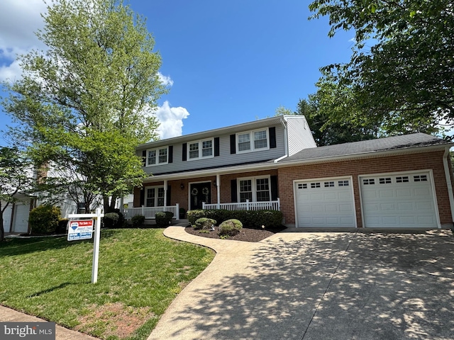 traditional-style home with a garage, a front yard, brick siding, a porch, and driveway
