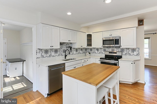 13407 Brookfield Dr, Chantilly, VA 20151 - kitchen with appliances with stainless steel finishes, a sink, white cabinetry, decorative backsplash, and recessed lighting