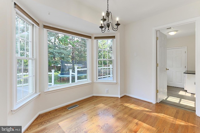 13407 Brookfield Dr, Chantilly, VA 20151 - unfurnished dining area featuring light wood-style floors, a chandelier, and baseboards