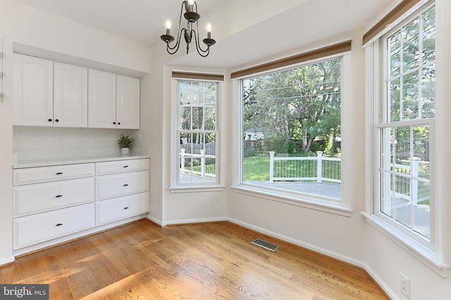 13407 Brookfield Dr, Chantilly, VA 20151 - unfurnished dining area featuring baseboards, light wood-style flooring, and plenty of natural light