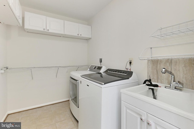 13407 Brookfield Dr, Chantilly, VA 20151 - laundry area featuring washing machine and clothes dryer, cabinet space, and light tile patterned floors