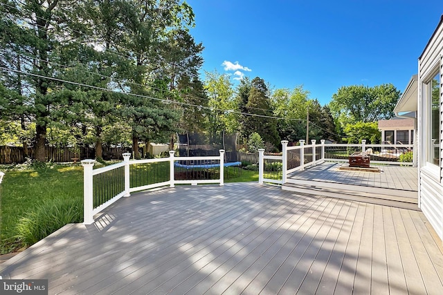 13407 Brookfield Dr, Chantilly, VA 20151 - wooden deck featuring a trampoline and view of scattered trees