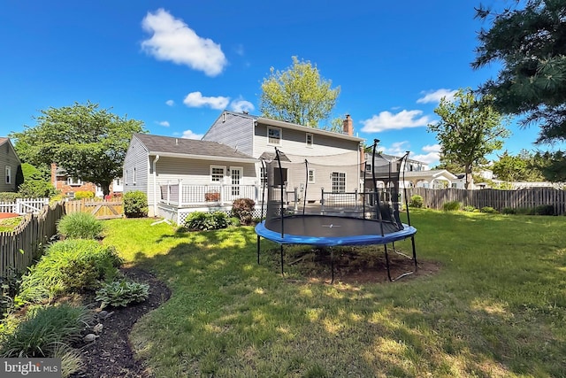 13407 Brookfield Dr, Chantilly, VA 20151 - back of house featuring a trampoline, a chimney, and a wooden deck
