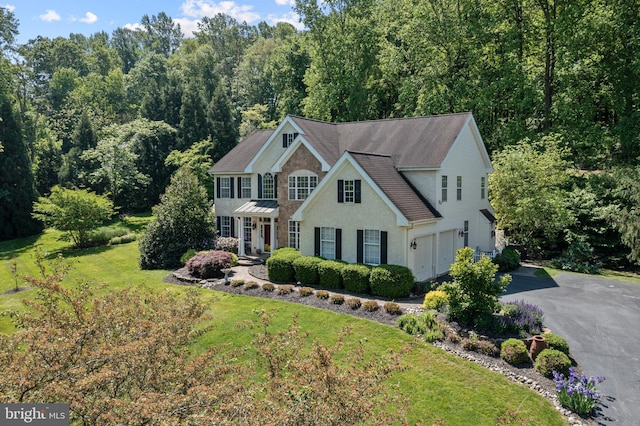 139 Watson Mill Rd, Landenberg, PA 19350 - colonial inspired home with asphalt driveway, an attached garage, a front lawn, and roof with shingles