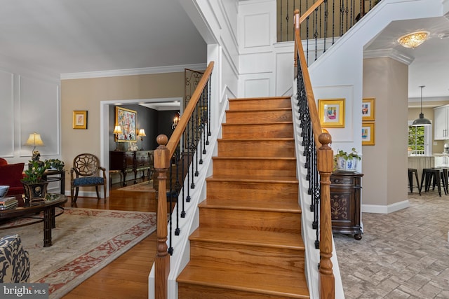 139 Watson Mill Rd, Landenberg, PA 19350 - stairs featuring a chandelier, baseboards, crown molding, and brick patterned floors