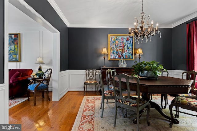 139 Watson Mill Rd, Landenberg, PA 19350 - dining area featuring light wood-style floors, a chandelier, a decorative wall, a wainscoted wall, and ornamental molding