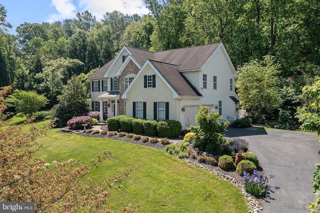 139 Watson Mill Rd, Landenberg, PA 19350 - colonial home featuring asphalt driveway, a front lawn, roof with shingles, and an attached garage