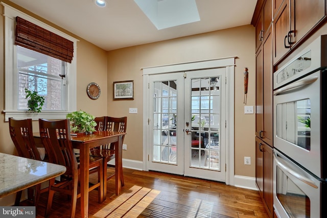 2636 N Calvert St N, Baltimore, MD 21218 - doorway to outside featuring a skylight, baseboards, light wood finished floors, and recessed lighting