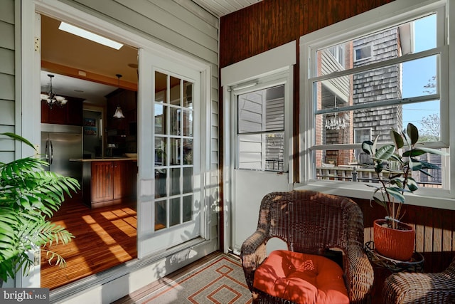 2636 N Calvert St N, Baltimore, MD 21218 - doorway to outside with wood finished floors, a chandelier, and wood walls