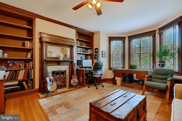 2636 N Calvert St N, Baltimore, MD 21218 - office featuring a ceiling fan, healthy amount of natural light, wood finished floors, and built in shelves