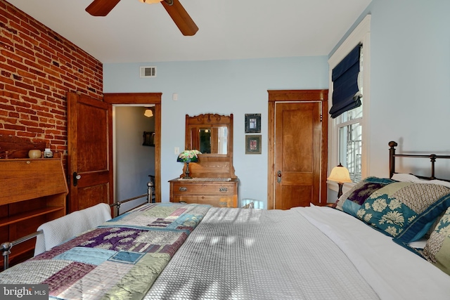 2636 N Calvert St N, Baltimore, MD 21218 - bedroom with brick wall and ceiling fan