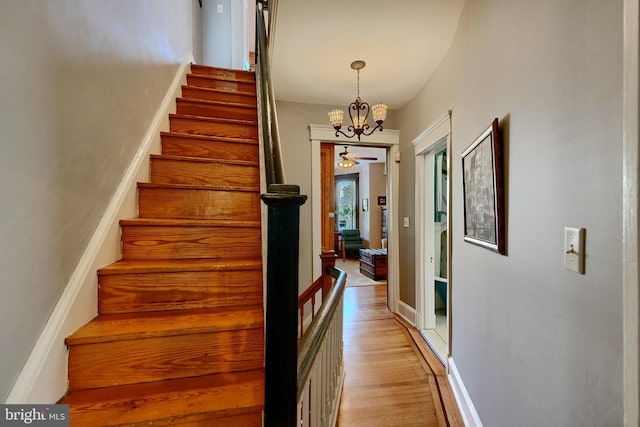 2636 N Calvert St N, Baltimore, MD 21218 - staircase featuring a chandelier and wood finished floors