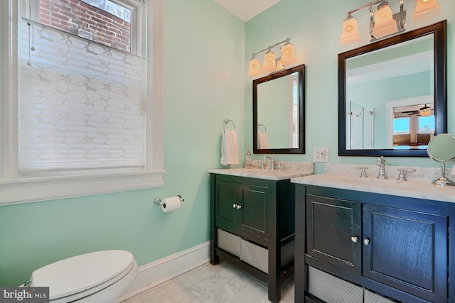 2636 N Calvert St N, Baltimore, MD 21218 - bathroom featuring vanity, baseboards, plenty of natural light, and toilet