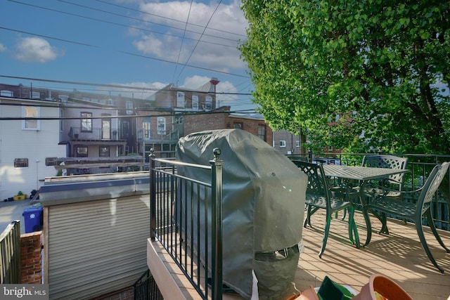 2636 N Calvert St N, Baltimore, MD 21218 - wooden deck with a grill and outdoor dining space