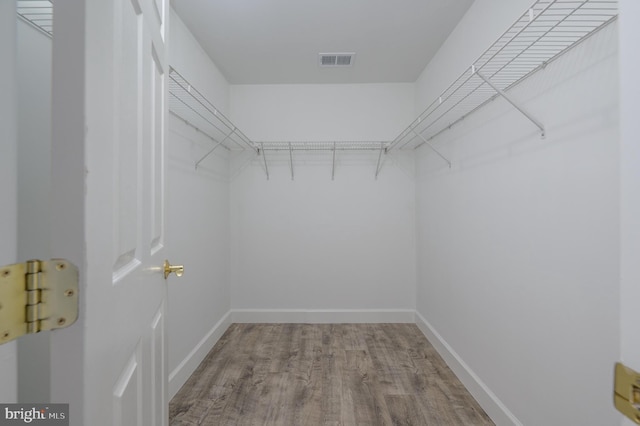 spacious closet with visible vents and wood finished floors