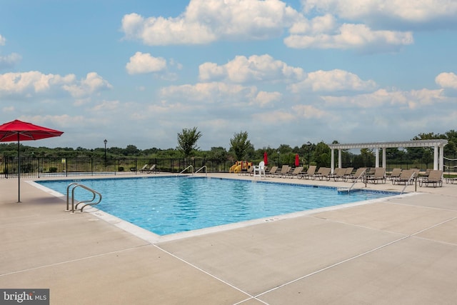 pool with a patio, fence, and a pergola