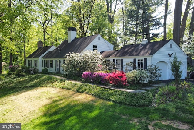 rear view of house with a yard and a chimney