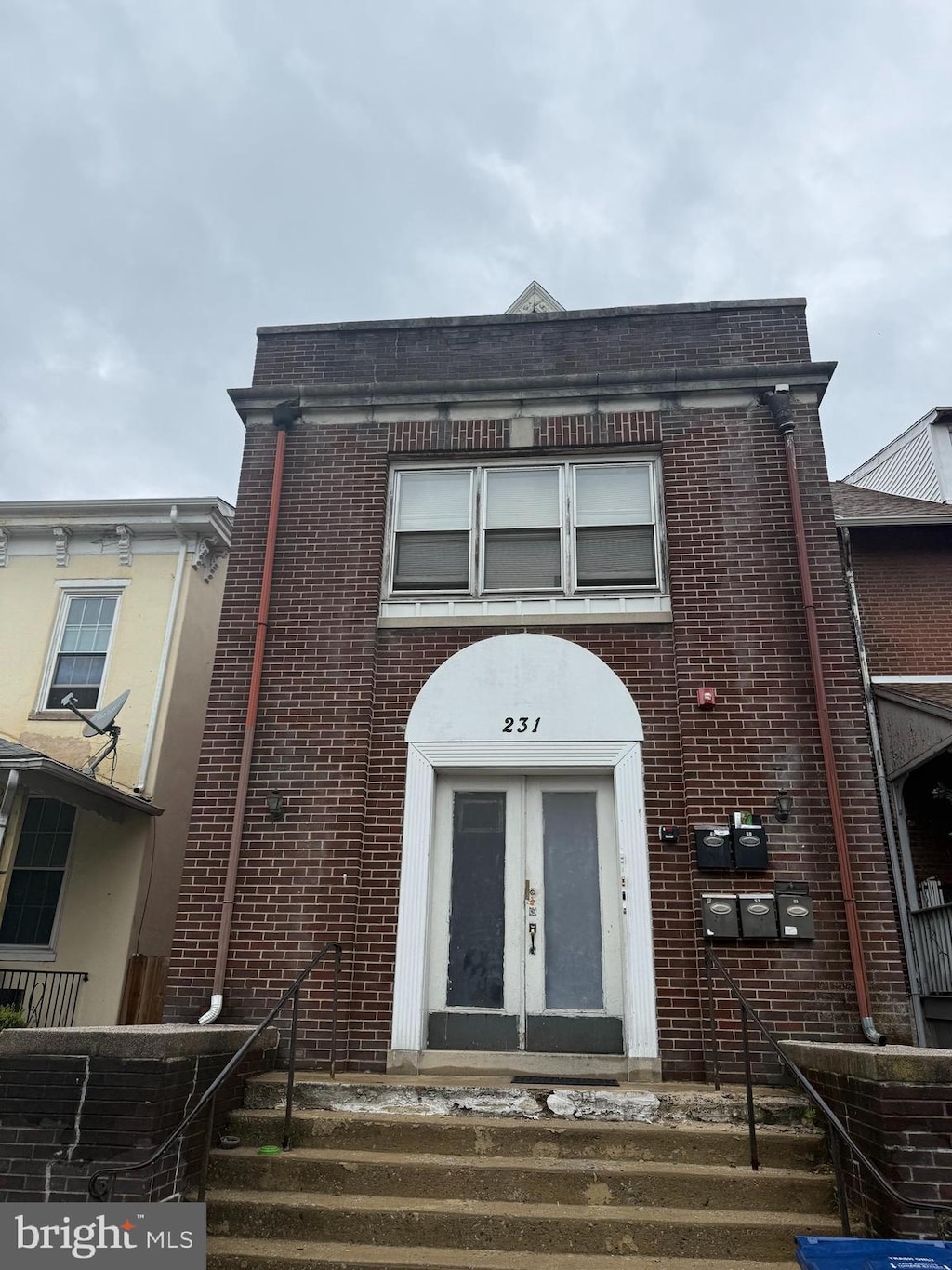townhome / multi-family property with brick siding and french doors