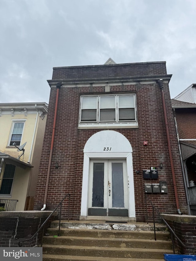 townhome / multi-family property with brick siding and french doors
