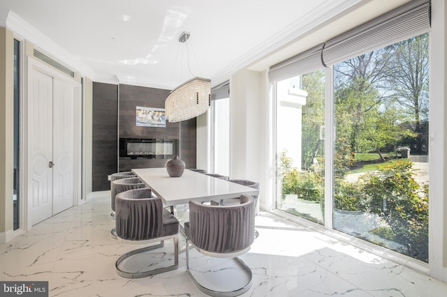 kitchen featuring marble tiled floors, a fireplace, and pendant lighting