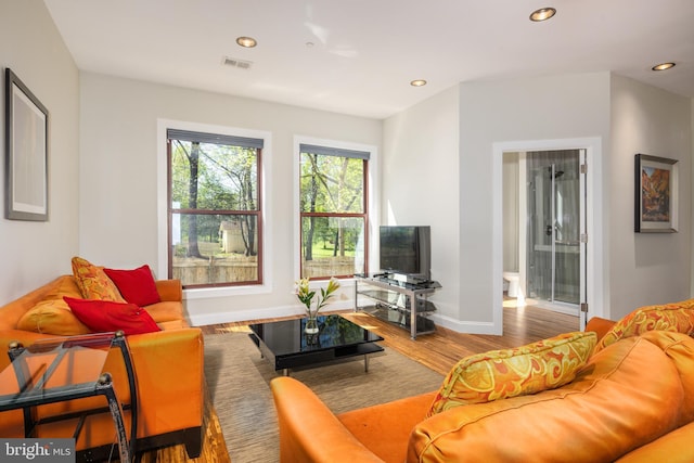 living room with wood finished floors, recessed lighting, and baseboards