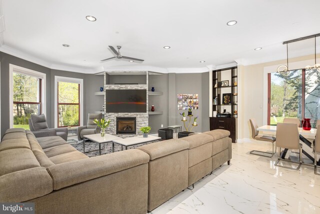 living area with recessed lighting, a stone fireplace, ornamental molding, a ceiling fan, and light marble finish floors